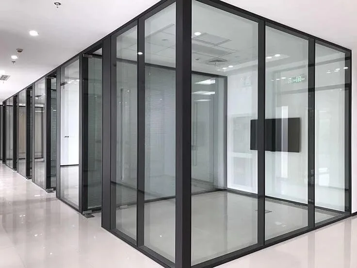 Floor-to-ceiling glass partitions dividing an open-plan office floor