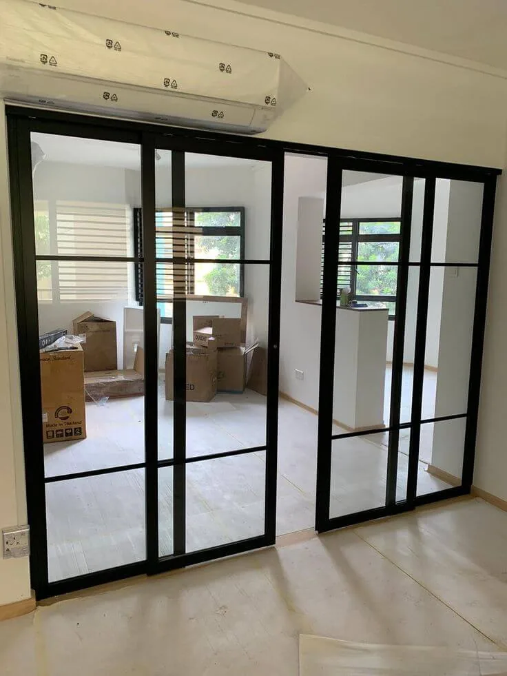 Slim-framed internal aluminium doors dividing a living and dining space