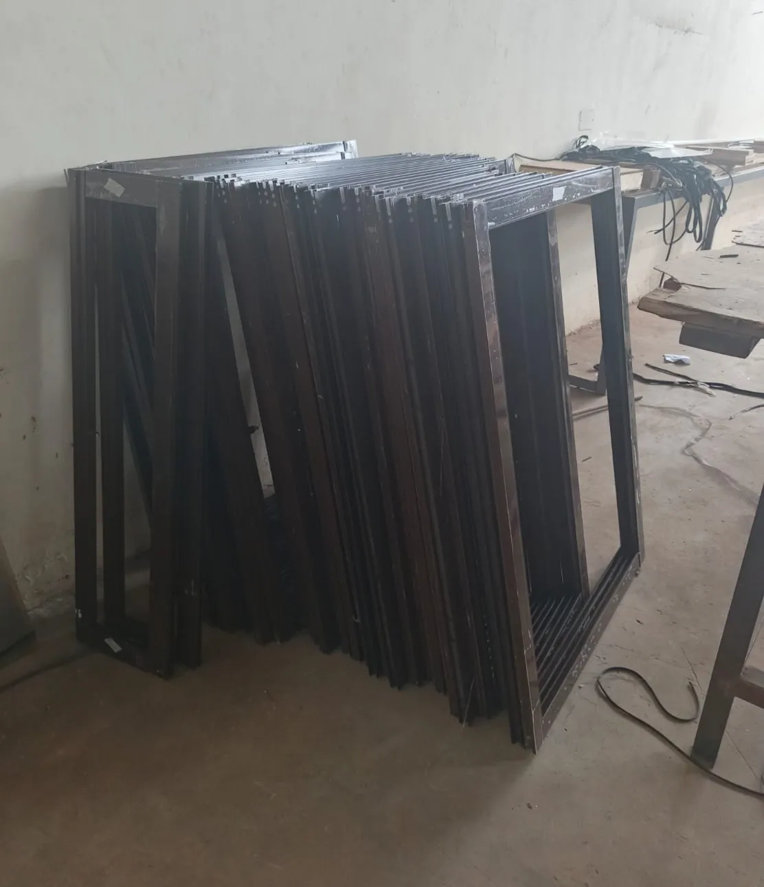 Powder-coated dark aluminium frames batched and ready for glazing