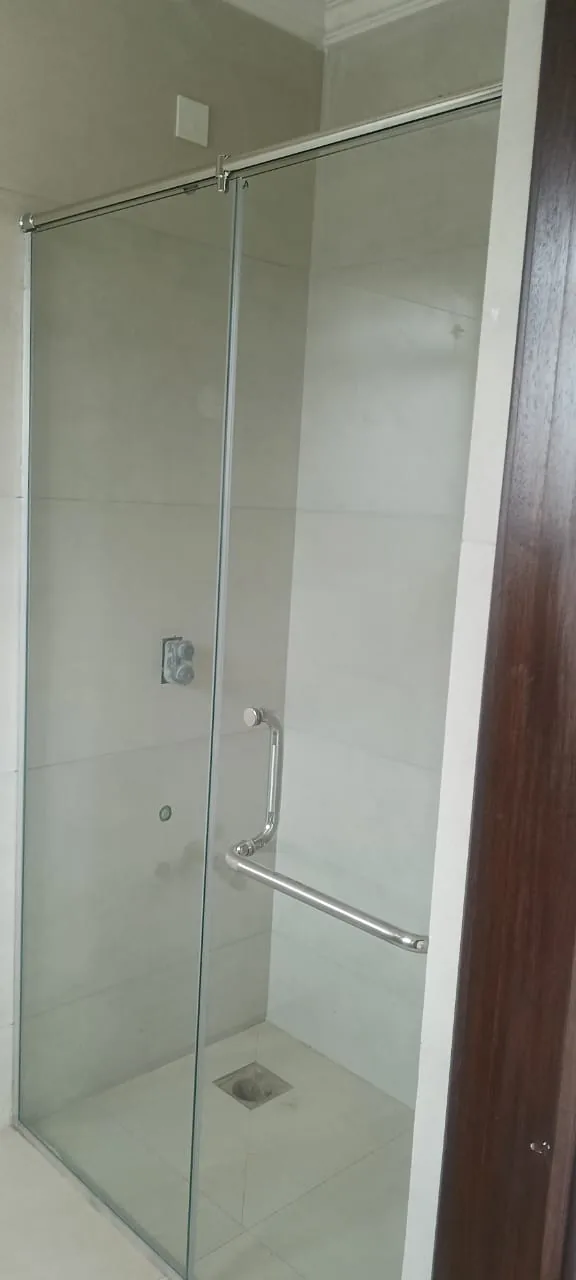 Sliding shower enclosure fitted into an out-of-square bathroom recess
