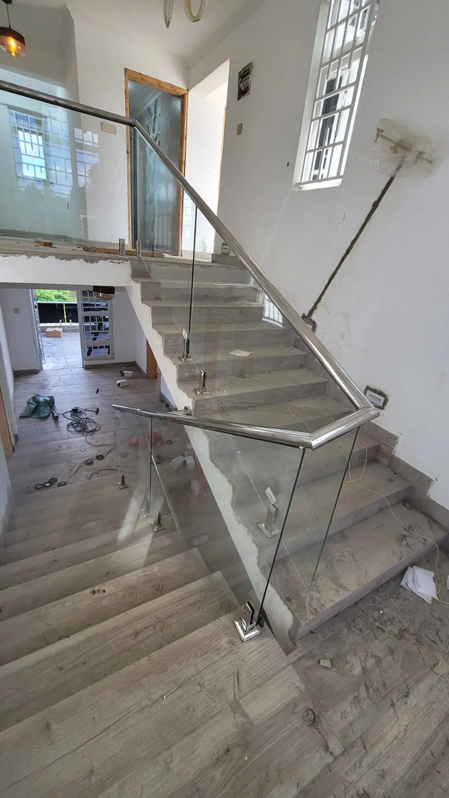 Stainless-post glass balustrade following a staircase through a new build