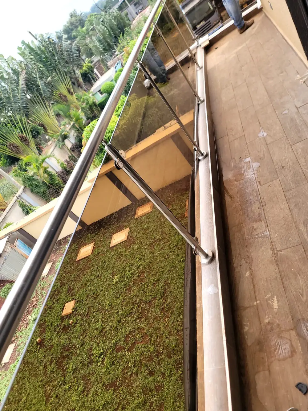 Stainless handrail and glass balustrade running along a first-floor terrace